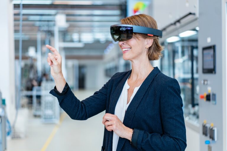Smiling businesswoman wearing AR glasses in a modern factory